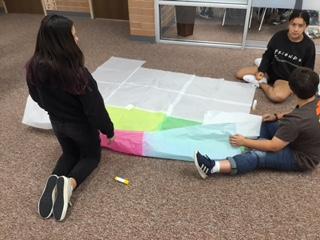STEM classes working on gluing hot air balloons