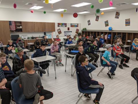 Students listening to rules of lego club