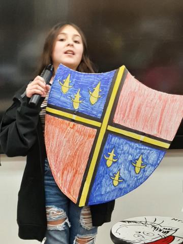 student holding shield project