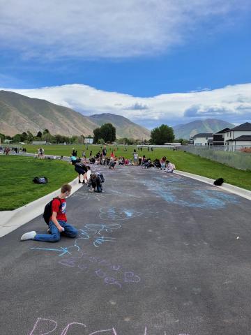 kids drawing with chalk outside