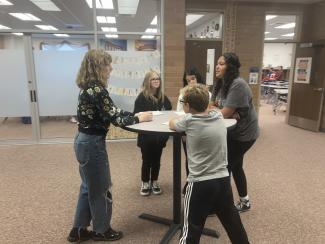 drama students teaching middle school kids in hallway